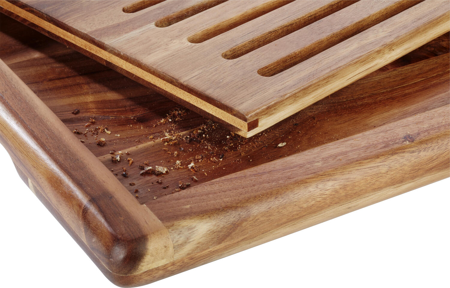 APS Assheuer + Pott GmbH & Co. KG Bread cutting board Akazia Brotschneidebrett AKAZIA, Akazienholz Bread cutting board Akazia; 53x32.5x2.5 cm (LxWxH); brown Brotschneidebrett AKAZIA, Akazienholz; 53x32.5x2.5 cm (LxBxH); braun Non-slip. The Akazia bread cutting board from APS impresses with its high-quality acacia wood design and a removable crumb tray. Acacia wood design and a removable crumb tray. The four attached non-slip feet ensure non-slip stability. Das Brotschneidebrett aus Akazienholz bietet eine praktische und durchdachte Lösung für das Schneiden von Brot und Backwaren. Die integrierte Auffangmöglichkeit sorgt dafür, dass Krümel sauber gesammelt werden und die Arbeitsfläche ordentlich bleibt. Dank der stabilen Ausführung und rutschhemmenden Elemente ist ein sicheres Arbeiten gewährleistet – ideal für Küche, Gastronomie und Haushalt. * Gefertigt aus hochwertigem Akazienholz * Mit herausnehmbarem Fach zum Auffangen von Krümeln * Rutschhemmende Standfüße für sicheren Halt * Stabil und langlebig im täglichen Gebrauch * Stapelbar für platzsparende Aufbewahrung * Feucht abwischbar * Für Küche, Gastronomie und privaten Einsatz geeignet