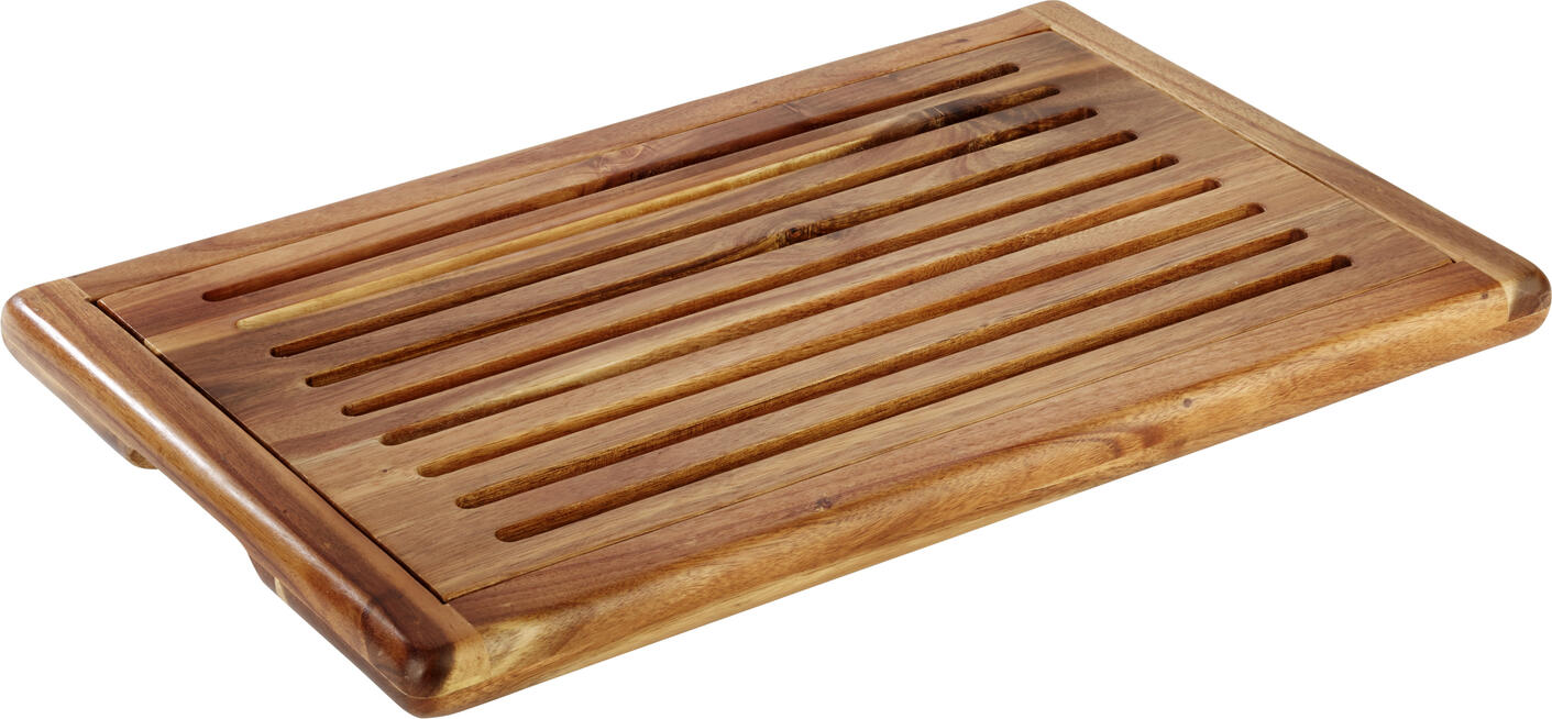 APS Assheuer + Pott GmbH & Co. KG Bread cutting board Akazia Brotschneidebrett AKAZIA, Akazienholz Bread cutting board Akazia; 60x40x2 cm (LxWxH); brown Brotschneidebrett AKAZIA, Akazienholz; 60x40x2 cm (LxBxH); braun Non-slip. The Akazia bread cutting board from APS impresses with its high-quality acacia wood design and a removable crumb tray. Acacia wood design and a removable crumb tray. The four attached non-slip feet ensure non-slip stability. Das Brotschneidebrett aus Akazienholz bietet eine praktische und durchdachte Lösung für das Schneiden von Brot und Backwaren. Die integrierte Auffangmöglichkeit sorgt dafür, dass Krümel sauber gesammelt werden und die Arbeitsfläche ordentlich bleibt. Dank der stabilen Ausführung und rutschhemmenden Elemente ist ein sicheres Arbeiten gewährleistet – ideal für Küche, Gastronomie und Haushalt. * Gefertigt aus hochwertigem Akazienholz * Mit herausnehmbarem Fach zum Auffangen von Krümeln * Rutschhemmende Standfüße für sicheren Halt * Stabil und langlebig im täglichen Gebrauch * Stapelbar für platzsparende Aufbewahrung * Feucht abwischbar * Für Küche, Gastronomie und privaten Einsatz geeignet